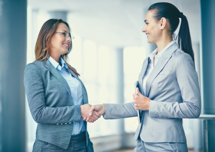 Image of two confident businesswomen handshaking